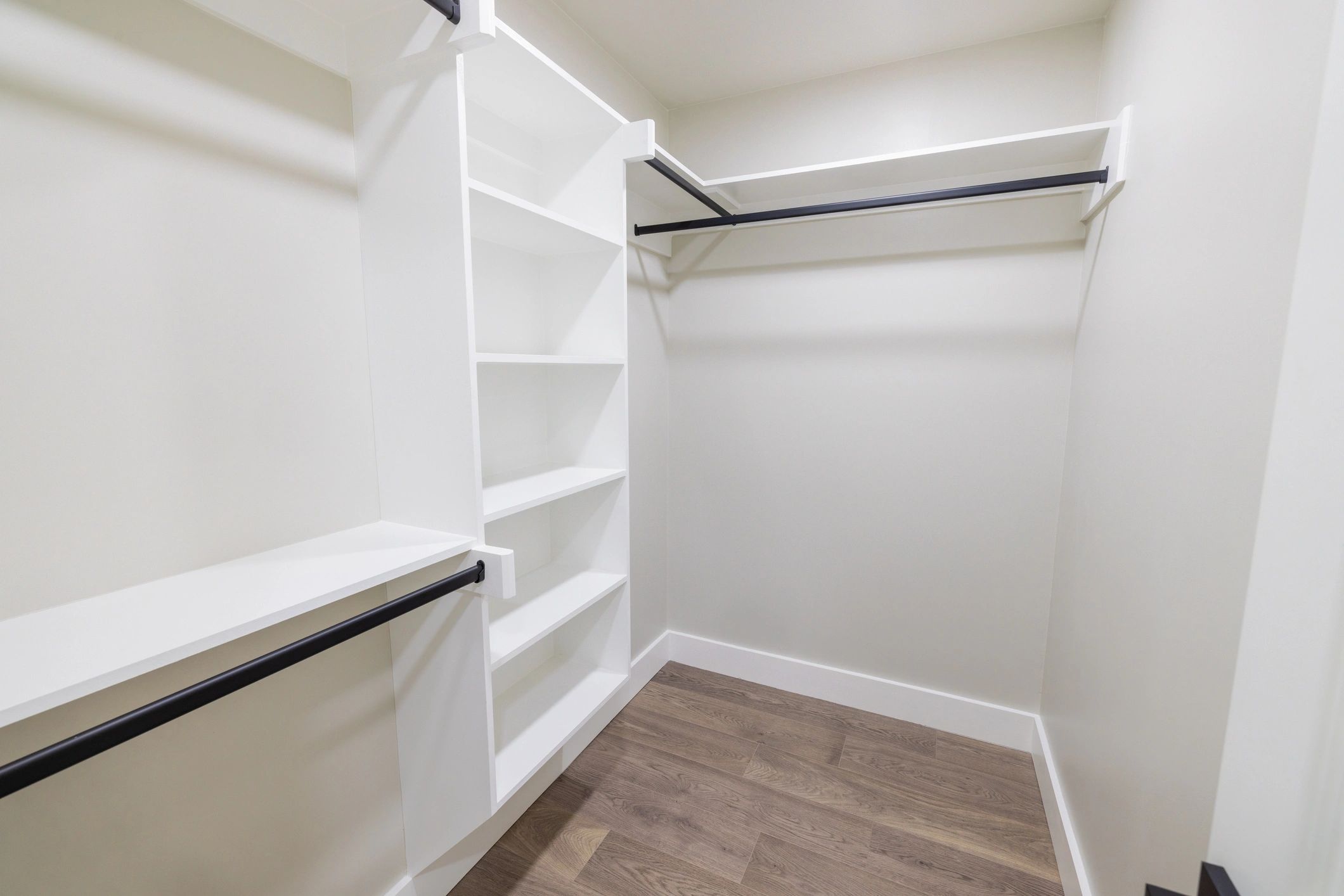 Custom closet installation with shoe racks and hanging space